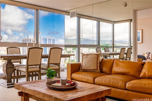 sunroom featuring visible vents and a city view