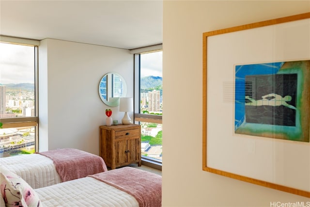 bedroom with a mountain view and a wall of windows