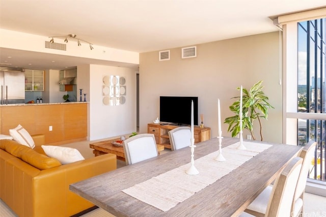 dining space featuring expansive windows and visible vents