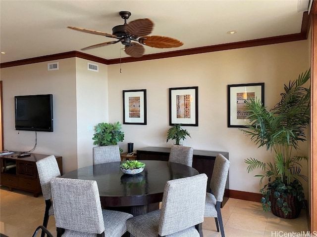 tiled dining area featuring ceiling fan and ornamental molding