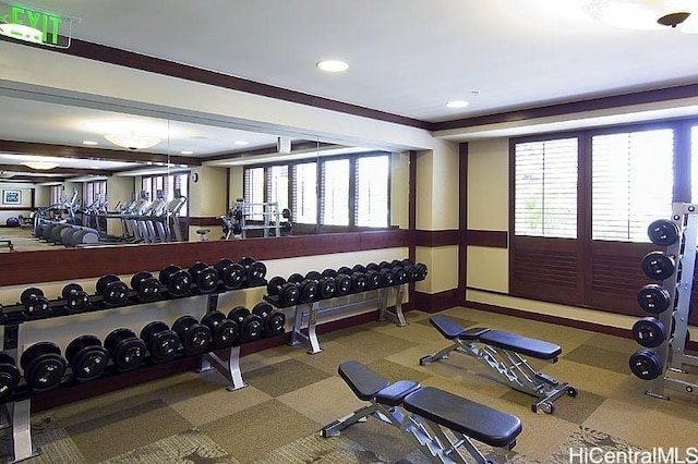 exercise room featuring baseboards, a wealth of natural light, and recessed lighting