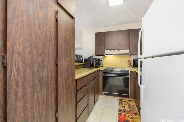 kitchen featuring black electric range oven, white fridge, and a textured ceiling