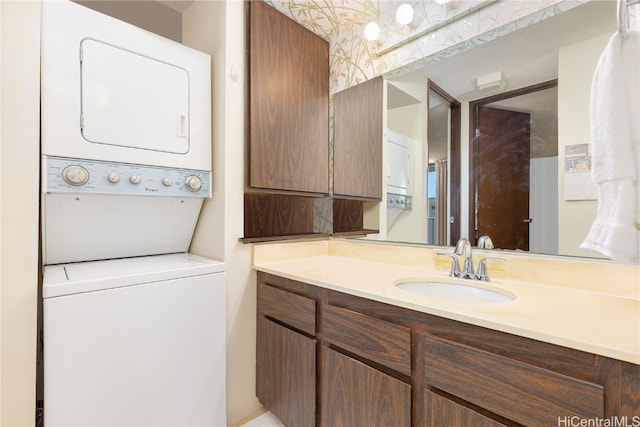 bathroom featuring vanity and stacked washer / drying machine