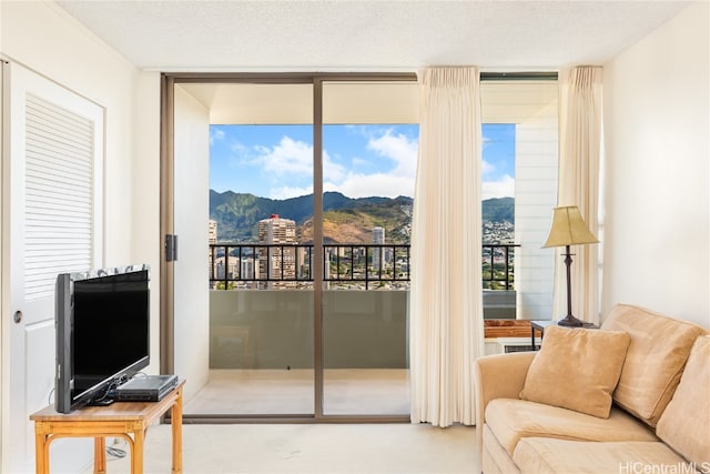 doorway to outside featuring a textured ceiling and floor to ceiling windows