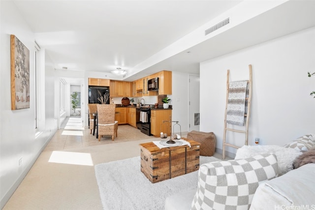 living room with sink and light tile patterned floors