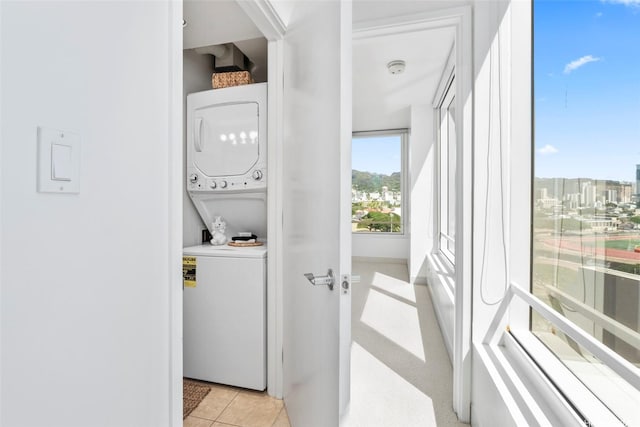 laundry room featuring stacked washer and dryer and laundry area