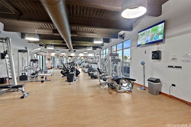 exercise room featuring hardwood / wood-style floors and wood ceiling