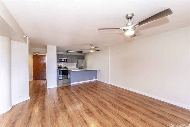 unfurnished living room featuring light hardwood / wood-style flooring and ceiling fan