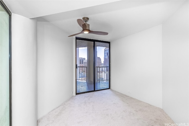 empty room with light colored carpet and ceiling fan