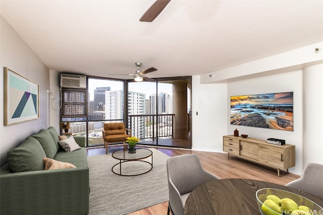 living room with hardwood / wood-style floors, a textured ceiling, and expansive windows