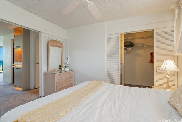 bedroom with a textured ceiling, carpet floors, a closet, and ceiling fan