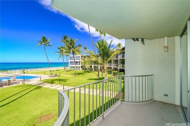 balcony featuring a water view and a view of the beach