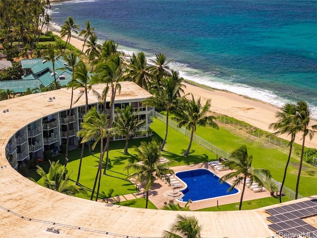 view of swimming pool with a water view and a view of the beach