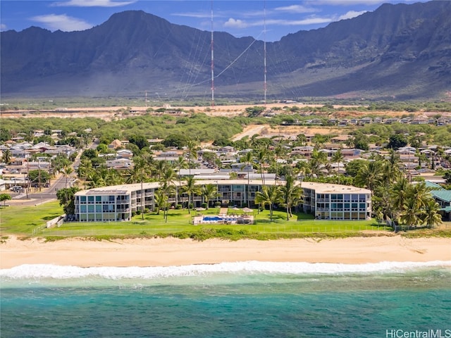 exterior space with a beach view and a water and mountain view