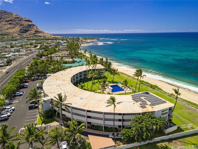 drone / aerial view featuring a water view and a view of the beach