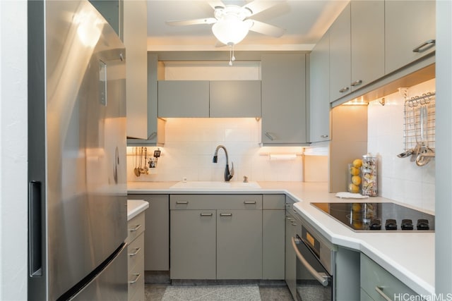 kitchen with decorative backsplash, black electric stovetop, ceiling fan, sink, and stainless steel fridge with ice dispenser