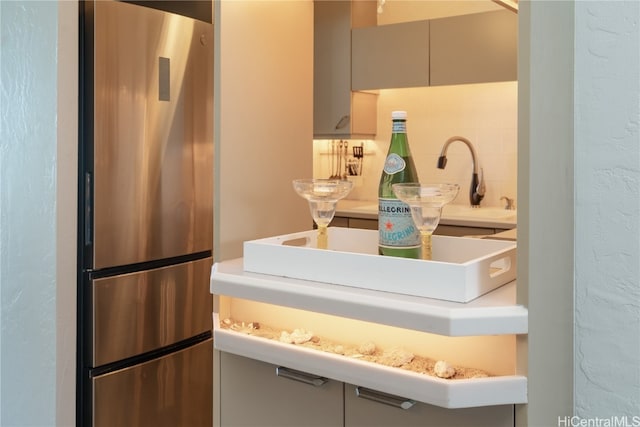 kitchen featuring backsplash and stainless steel refrigerator