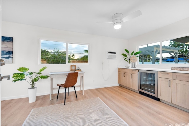 kitchen featuring light brown cabinets, beverage cooler, and a healthy amount of sunlight