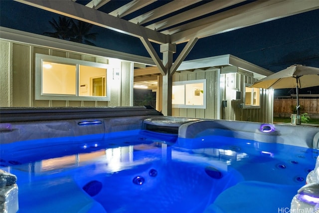 view of pool with a hot tub