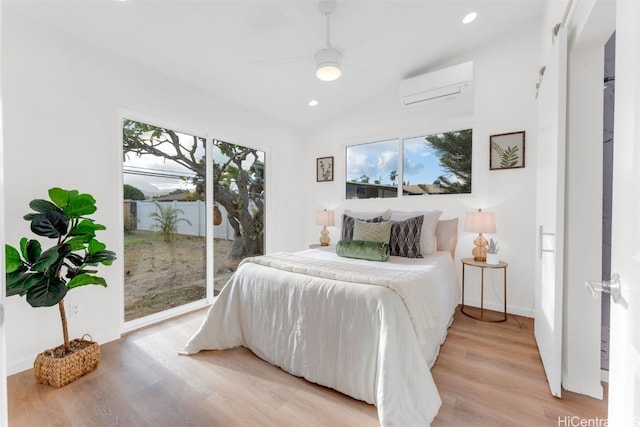 bedroom with lofted ceiling, ceiling fan, access to exterior, light wood-type flooring, and a wall mounted AC