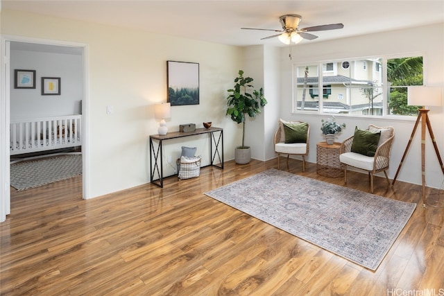 living area with ceiling fan and hardwood / wood-style floors