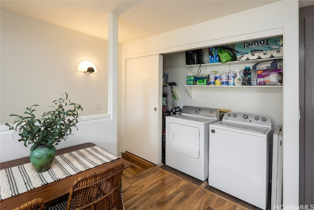 clothes washing area featuring dark hardwood / wood-style flooring and separate washer and dryer