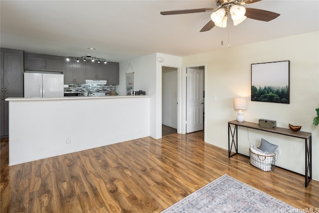 living room with ceiling fan and dark hardwood / wood-style flooring