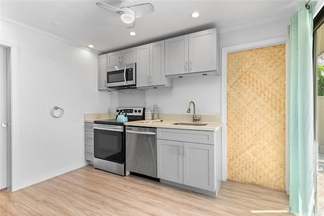 6125B Summer St Unit 6125B, Honolulu, HI 96821 - kitchen with stainless steel appliances, light wood-style floors, light countertops, ornamental molding, and a sink