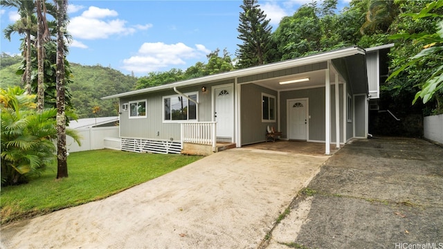 view of front facade with a front lawn and a carport