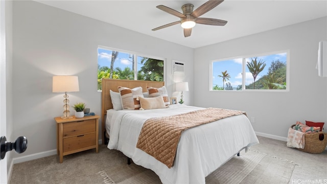 bedroom featuring multiple windows, carpet floors, and ceiling fan