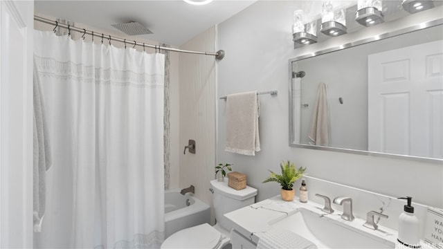 full bathroom with vanity, shower / bath combo, and toilet