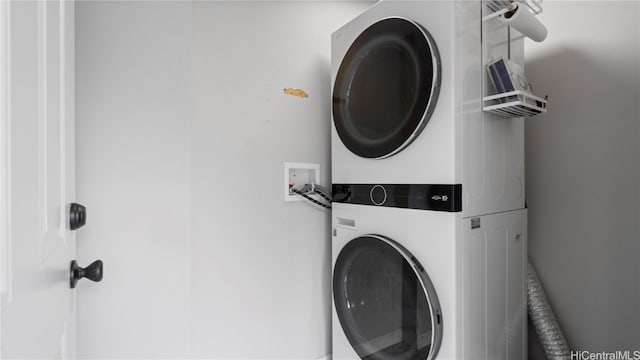 laundry room with stacked washer / dryer