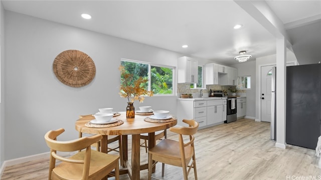 dining room featuring light hardwood / wood-style floors and sink