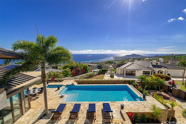 view of swimming pool with a mountain view and a patio area