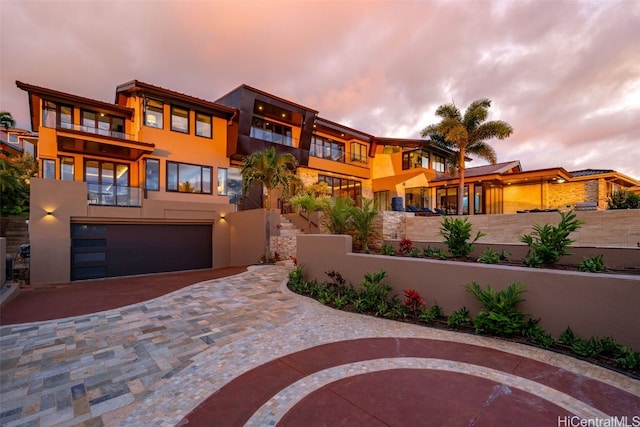 view of front of house with a garage and a balcony