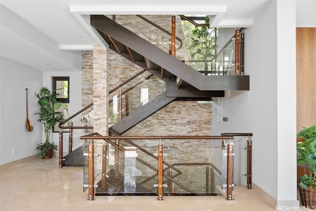 staircase featuring a high ceiling