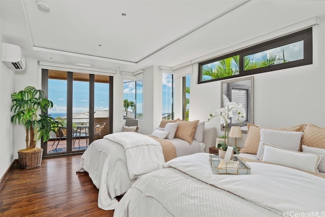 bedroom with a wall unit AC, dark hardwood / wood-style floors, and access to outside