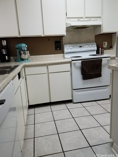 kitchen featuring white cabinetry, light tile patterned flooring, and white appliances