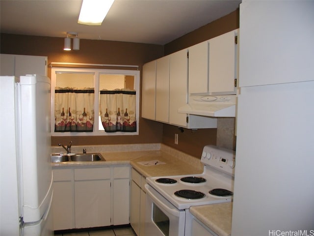 kitchen featuring sink, white cabinets, and white appliances