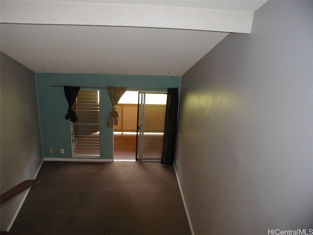 empty room with lofted ceiling and carpet floors