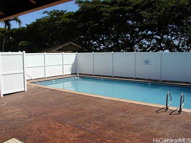 view of swimming pool featuring a patio area