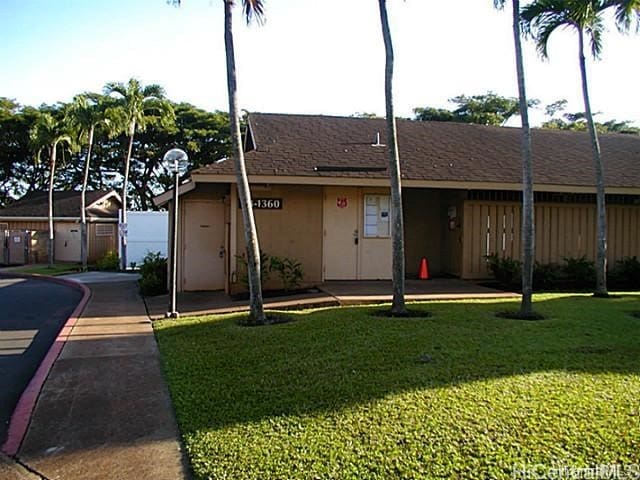 ranch-style house with a front lawn