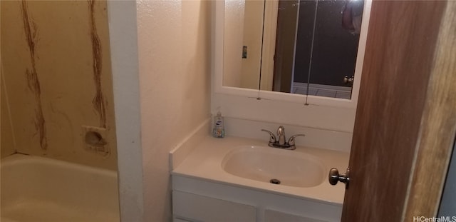 bathroom with vanity and a bathtub