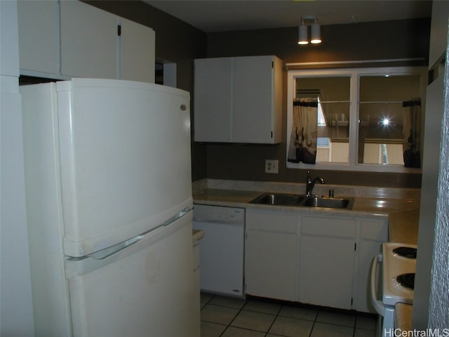 kitchen with white cabinetry, sink, light tile patterned floors, and white appliances