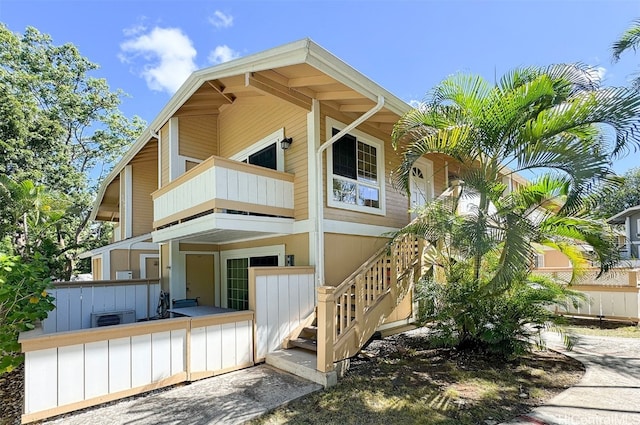 rear view of property featuring central air condition unit and a balcony