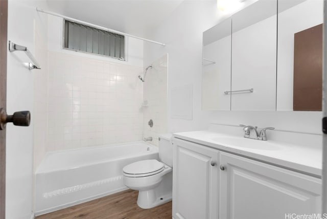 full bathroom with vanity, toilet, tiled shower / bath combo, and hardwood / wood-style floors