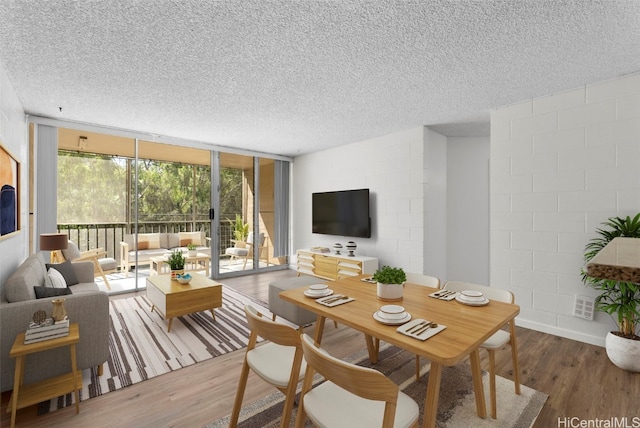 interior space featuring a textured ceiling, floor to ceiling windows, and hardwood / wood-style floors