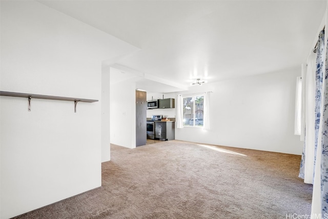 unfurnished living room featuring light colored carpet