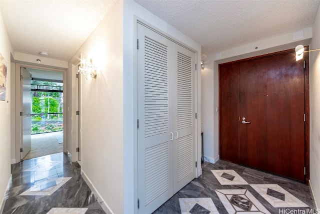 corridor featuring a textured ceiling