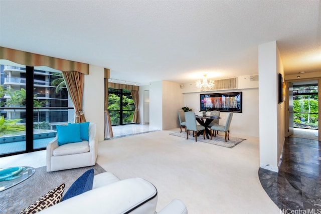 carpeted living room featuring a textured ceiling and a chandelier